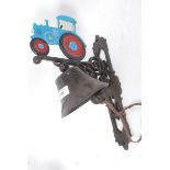 A 20th century cast iron wall hanging bell with farm tractor to top, hand painted