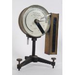 A 20th century Torsion balance scale having bevelled glass with brass surround raised on