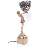 A good Art Deco Tiffany style lamp in the form of a lady holding a coloured glass lamp.