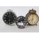 A collection of alarm clocks to include a Westclox and two others.