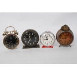 A collection of alarm clocks to include a Sturm clock, Westclox and two others.