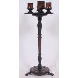 A decorative 20th century ebonised Victorian mahogany tripod smokers stand complete with the inset