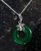 A silver and jade hoop set necklace on w