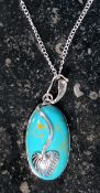 A silver and turqoise pendant necklace o