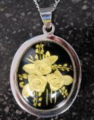 A silver and floral intaglio pendant on