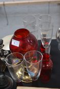 An assortment of cranberry glass