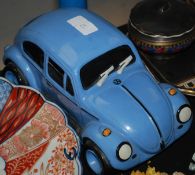 A Volkswagen Beetle porcelain money box in blue with cork stopper