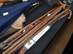 A collection of vintage walking sticks and canes