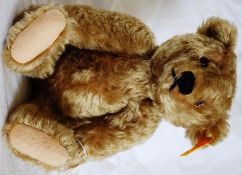 A 20th century Steiff teddy bear 000713 with button and tag to ear. Soft mohair covering with humped