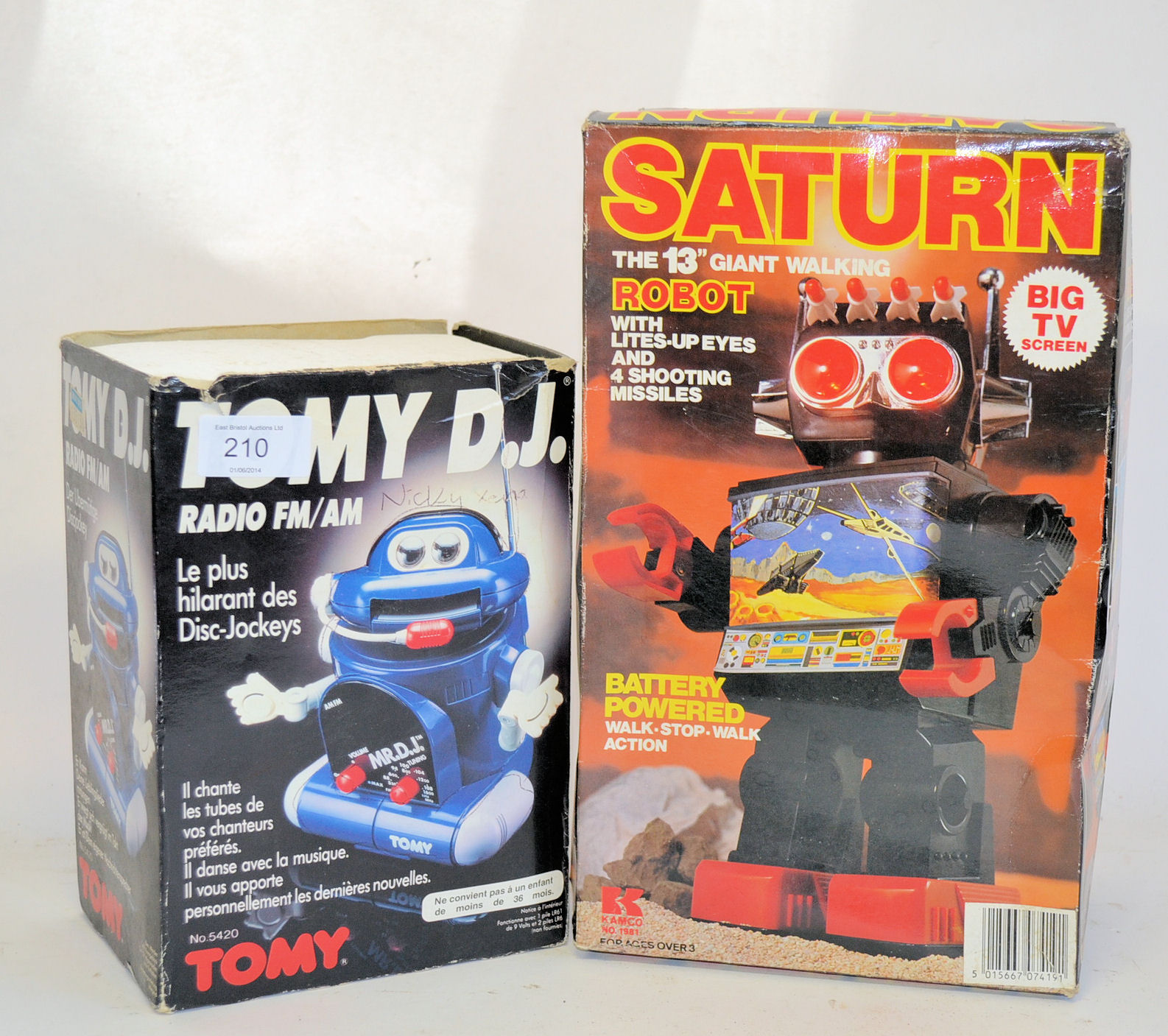 A vintage boxed Saturn 13" Walking battery operated robot, along with a boxed Tomy DJ robot.