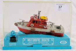 A vintage Ideal Motorific Boats Battery Operated Marine Motor Automatic Bailer model plastic boat,