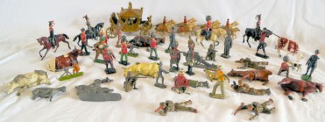 A collection of early - mid 20th century lead figures, including soldiers, animals, people,