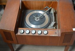A Marconi Teak affect Record Player of small proportions with a garrard deck. Standing on legs.