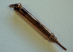 A 9ct gold minature propelling pencil with finial and ring atop. Unmarked, tested as 9ct