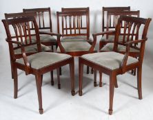 A set of 8 Regency style mahogany dining chairs. Raised on sabre supports with blue velour drop in