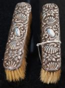 A pair of Victorian Charles James Fox hallmarked silver rococo clothes brushes, Chester 1898.