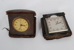 A vintage Keinzle travel pocket clock along with another with affixed metal plaque for 1922.
