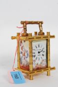 A decorative carriage clock in a bamboo style case.