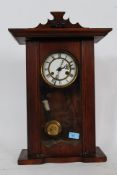 A vitnage enamel faced wall clock with Vienna regulator in mahogany case.