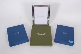 Two boxed 20th century unused Carrs silver plate photograph frames, along with a Cristofle white