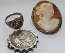 A ladies silver Victorian brooch hallmarked to verso having copper birds and flowers to centre.