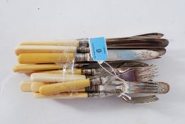 A collection of 24 hallmarked silver banded knives and forks, each with bone handles.