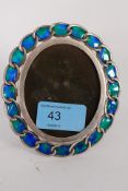 A white metal silver and enamel set picture frame