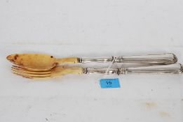 An antique silver hallmarked and bone tipped long spoon and fork