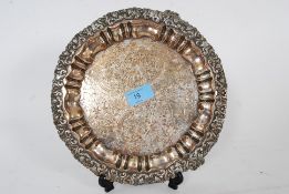 An antique silver plate dish / cake stand, standing on art nouveau feet with detailed floral