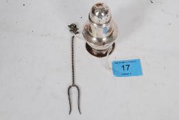 A hallmarked silver pepper pot and hallmarked silver fish fork with delicate flower to top.