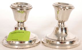 A pair of hallmarked silver stub candlesticks bearing Birmingham hallmarks inscribe with makers