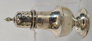 A hallmarked sterling silver sugar sifter / condiment shaker with chased star decoration to cap.