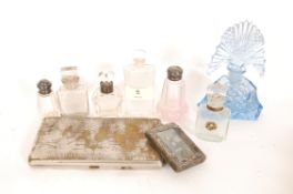 A collection of silver topped perfume bottles to  include 2 with silver tops, 1 with silver