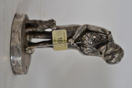A hallmarked sterling silver figure of a lady golfer with terrier dog