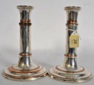 A pair of Georgian style silver plate adjustable candlesticks