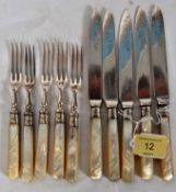 A collection of two hallmarked silver banded and mother of pearl handled knives and forks, each