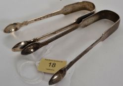 Two pairs of hallmarked silver sugar tongs, one being monogrammed to top. Each having hallmarks to