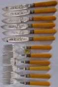 A set of 12 hallmarked silver banded matching knives and forks, with makers mark JH Potter.