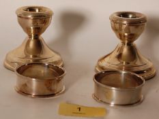 A B&C hallmarked sterling silver pair of napkin rings and candlesticks - both still in original