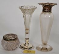 A collection of hallmarked silver lidded glass items to include two vases and a lidded pot.