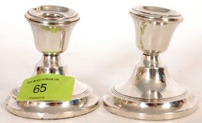 A pair of hallmarked silver stub candlesticks bearing Birmingham hallmarks inscribe with makers