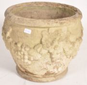 A large traditional garden planter pot being cast with grape and vine decoration to the circular