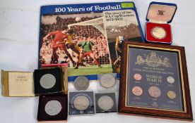 A collection of commemorative coins, some in cases to include 100 years of football (complete)