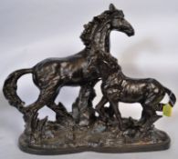 A large 20th century cast iron figural group of horses, on a large heavyweight cast iron