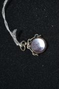 A silver hallmarked ladies swivel pendant inset with agate stone bearing partially illegible