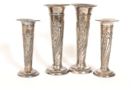 A set of 4 unusual silver plated candlestick holders raised in relief with scrolling foliates to the