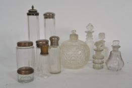 A collection of early 20th century cut glass perfume viles and bottle having silver plate tops.