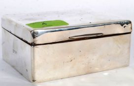 A hallmarked silver cigarette box with plain design and hallmarks to side