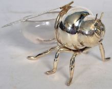 A 20th century silver plate and glass honey pot in the form of a bee.