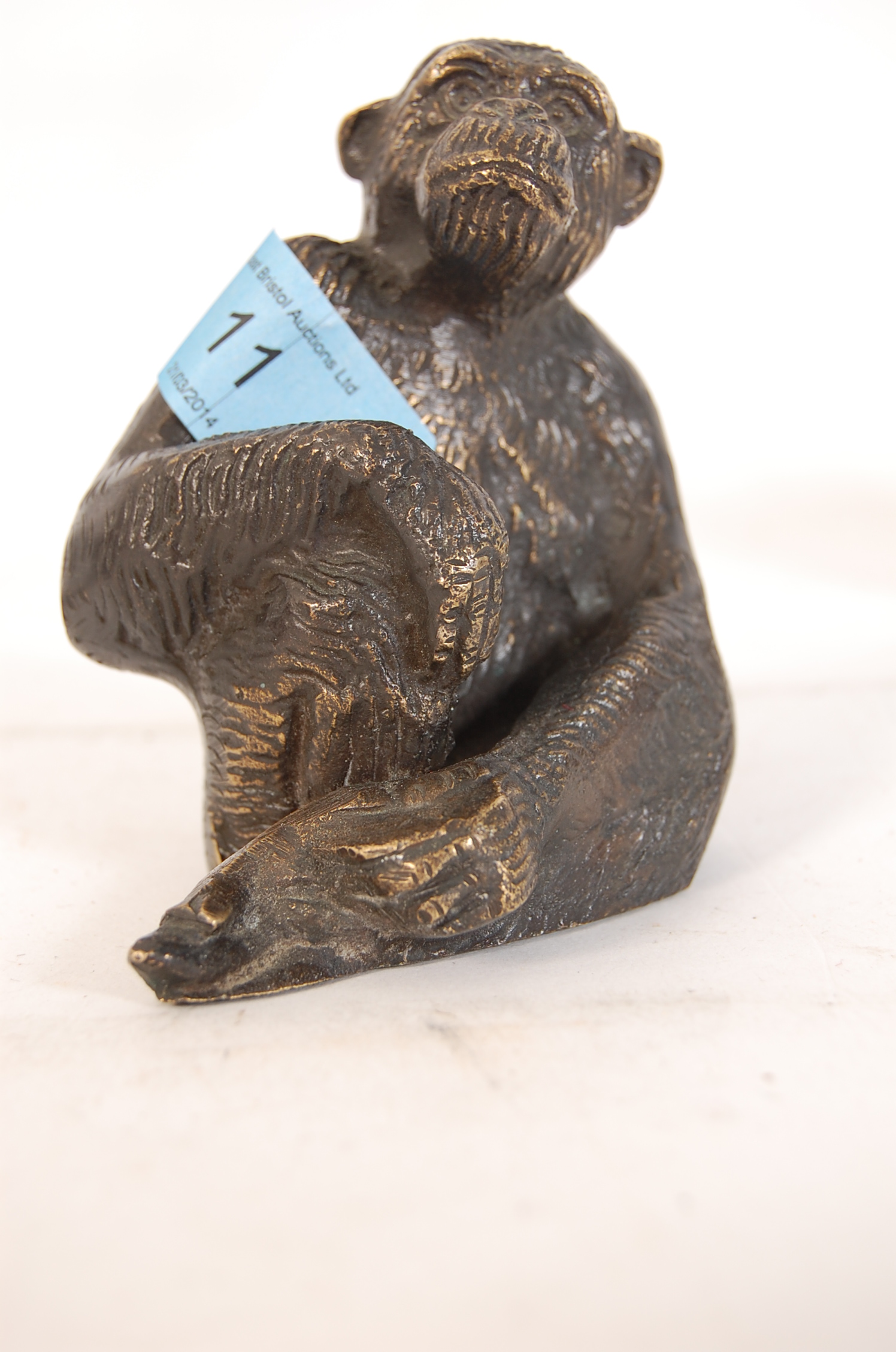 A bronze cast figurine of a Monkey, of Chinese origin(unsigned) (Height 10cms)